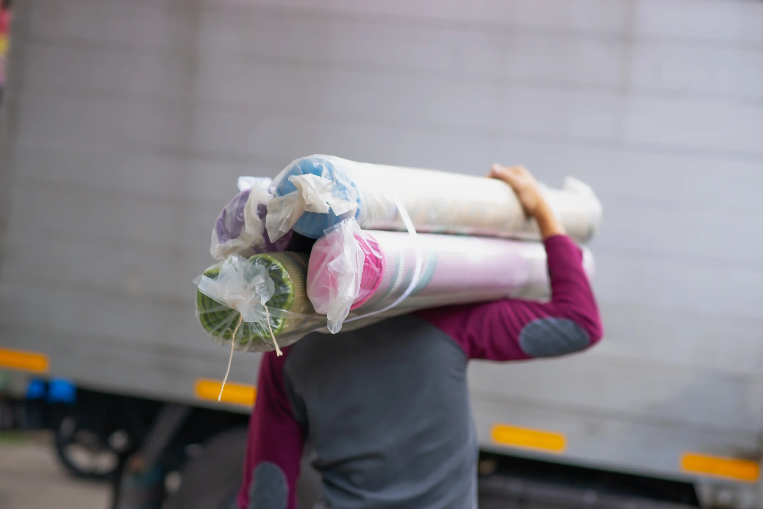 man is shouldering carpet_11zon scaled